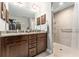 Bathroom featuring double sinks, granite counters and a walk-in shower at 9945 Sw 55Th Avenue Rd, Ocala, FL 34476