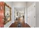 Elegant entryway featuring hardwood floors and a decorative mirror, leading to the living spaces at 9945 Sw 55Th Avenue Rd, Ocala, FL 34476