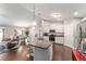 Bright kitchen with stainless steel appliances and bar seating that opens to living area at 9945 Sw 55Th Avenue Rd, Ocala, FL 34476