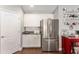 Well-lit kitchen with stainless steel refrigerator and ample cabinet space at 9945 Sw 55Th Avenue Rd, Ocala, FL 34476