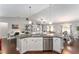 Open kitchen featuring a large island with seating, overlooking the living and dining areas at 9945 Sw 55Th Avenue Rd, Ocala, FL 34476