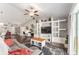 Inviting living room featuring vaulted ceilings, a ceiling fan, and a custom entertainment center at 9945 Sw 55Th Avenue Rd, Ocala, FL 34476