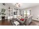 Bright living room with built-in shelving, ceiling fan, and sliding glass door to the patio at 9945 Sw 55Th Avenue Rd, Ocala, FL 34476