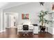 Bright office nook featuring hardwood floors, a white desk, and decorative wall art, adjacent to the living area at 9945 Sw 55Th Avenue Rd, Ocala, FL 34476