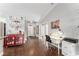 Bright office nook featuring hardwood floors, a white desk, and decorative wall art, adjacent to the living area at 9945 Sw 55Th Avenue Rd, Ocala, FL 34476