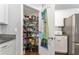 Walk-in pantry offers ample storage with shelving and organization, adjacent to kitchen at 9945 Sw 55Th Avenue Rd, Ocala, FL 34476