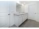 Bathroom with double sink vanity, white cabinets and tiled floor at 6683 Se 3Rd Loop, Ocala, FL 34472