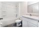 Bright bathroom features a tub, a sink, and a toilet at 6683 Se 3Rd Loop, Ocala, FL 34472