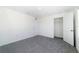 Neutral bedroom with gray carpet, white walls, and a walk-in closet at 6683 Se 3Rd Loop, Ocala, FL 34472