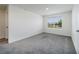Bright bedroom with gray carpet, white walls, and a window at 6683 Se 3Rd Loop, Ocala, FL 34472