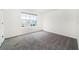 Bright bedroom features a window and neutral gray carpet at 6683 Se 3Rd Loop, Ocala, FL 34472