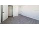 Neutral bedroom with gray carpet, white walls, and closet at 6683 Se 3Rd Loop, Ocala, FL 34472