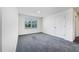 Bright bedroom with gray carpet, white walls, and a large window at 6683 Se 3Rd Loop, Ocala, FL 34472