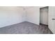 Neutral bedroom with gray carpet, white walls, and closet at 6683 Se 3Rd Loop, Ocala, FL 34472