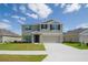Charming two-story home with a well-manicured lawn and attached two-car garage at 6683 Se 3Rd Loop, Ocala, FL 34472