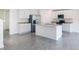 Open-concept kitchen with island, stainless appliances, and tile flooring at 6683 Se 3Rd Loop, Ocala, FL 34472