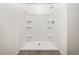 New bathroom shower stall with built-in shelving for added convenience and organized storage at 6683 Se 3Rd Loop, Ocala, FL 34472