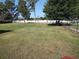 Spacious backyard showcasing a vast lawn with a white fence ensuring privacy and security at 10458 Sw 52Nd Ct, Ocala, FL 34476