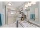 Bright bathroom with a glass-enclosed shower, granite countertop, and natural light at 10458 Sw 52Nd Ct, Ocala, FL 34476