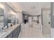 Bathroom featuring double vanity, tub, and walk-in shower with tile surround at 10458 Sw 52Nd Ct, Ocala, FL 34476