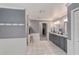 Well-lit bathroom featuring a double vanity, granite countertop, and tile flooring at 10458 Sw 52Nd Ct, Ocala, FL 34476