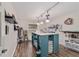 Bright craft room featuring a large work table, wood floors, and creative decor at 10458 Sw 52Nd Ct, Ocala, FL 34476