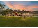 Charming single-story home with a manicured lawn, tasteful landscaping and a vibrant red front door at 10458 Sw 52Nd Ct, Ocala, FL 34476