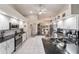 Bright kitchen with stainless steel appliances, black countertops, white cabinets, and tile floors at 10458 Sw 52Nd Ct, Ocala, FL 34476