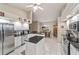Well-lit kitchen with stainless steel appliances, island, and adjacent dining area at 10458 Sw 52Nd Ct, Ocala, FL 34476
