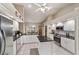 White kitchen with island and stainless appliances opens to eat in dining area at 10458 Sw 52Nd Ct, Ocala, FL 34476