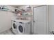 Well-organized laundry room with modern washer and dryer, plus storage shelves at 10458 Sw 52Nd Ct, Ocala, FL 34476