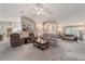 Spacious living room with an open layout, plush carpet, neutral tones, and seamless transitions to other areas at 10458 Sw 52Nd Ct, Ocala, FL 34476