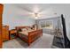 Light filled bedroom with ensuite bathroom and ceiling fan at 10458 Sw 52Nd Ct, Ocala, FL 34476