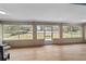 Bright sunroom with large windows offering great views of the backyard and greenery at 10458 Sw 52Nd Ct, Ocala, FL 34476