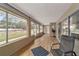 Spacious sunroom with hardwood floors and backyard views at 10458 Sw 52Nd Ct, Ocala, FL 34476