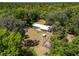 An expansive property features a quaint house and plenty of green space surrounded by lush trees at 18341 Nw 142Nd Court Rd, Williston, FL 32696