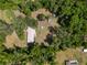 Aerial view of house with ample green space, enveloped by the embrace of abundant forestry at 18341 Nw 142Nd Court Rd, Williston, FL 32696