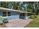 Beautiful home exterior with a brick patio, blue siding, and a spacious backyard at 18341 Nw 142Nd Court Rd, Williston, FL 32696