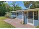 Charming home exterior featuring a blue facade, brick patio, and landscaped backyard at 18341 Nw 142Nd Court Rd, Williston, FL 32696