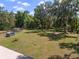 A large backyard with a storage shed, swing set and chicken coop at 18341 Nw 142Nd Court Rd, Williston, FL 32696