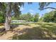 A spacious, well-maintained yard with mature trees, swing and a chicken coop at 18341 Nw 142Nd Court Rd, Williston, FL 32696