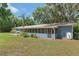 Exterior view of home showcasing large screened in porch and expansive yard at 18341 Nw 142Nd Court Rd, Williston, FL 32696