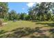 Expansive backyard featuring mature trees, ample green space, and outbuildings at 18341 Nw 142Nd Court Rd, Williston, FL 32696