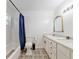 Updated bathroom features a shower-tub combo, vanity with storage, and stylish tile flooring at 18341 Nw 142Nd Court Rd, Williston, FL 32696