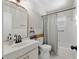 Bright bathroom featuring patterned floors, updated vanity, and a shower-tub combo at 18341 Nw 142Nd Court Rd, Williston, FL 32696