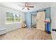 bedroom featuring a sliding barn door, light blue accent wall, and spacious layout at 18341 Nw 142Nd Court Rd, Williston, FL 32696