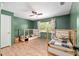 Shared bedroom featuring two twin beds with stylish wood frames and bright green walls at 18341 Nw 142Nd Court Rd, Williston, FL 32696