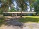 Charming single-story home with a metal roof, inviting porch, and mature trees at 18341 Nw 142Nd Court Rd, Williston, FL 32696