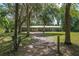 A home with metal roof and a long, tree-lined driveway sits nestled amongst mature trees at 18341 Nw 142Nd Court Rd, Williston, FL 32696