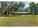 Inviting single-story home with lush green lawn and mature trees, offering a peaceful and idyllic setting at 18341 Nw 142Nd Court Rd, Williston, FL 32696